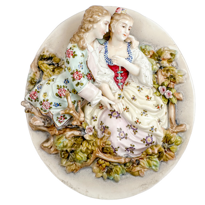 Pair early 19th Century porcelain Meissen style continental wall plaques, romantic scenes with lovers