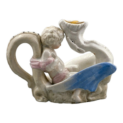 Georgian softpaste porcelain and creamware cherub candle chambersticks, putti on wyvern and leaf