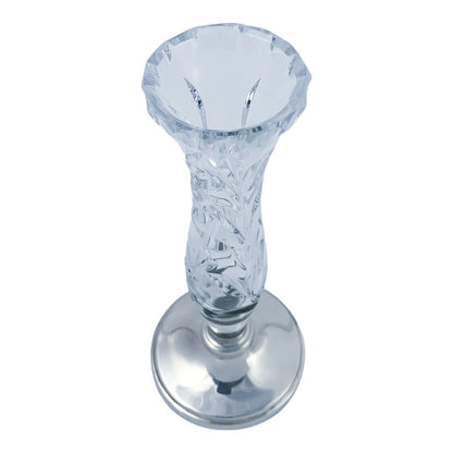 Vintage crystal flower vase resting on a sterling silver stepped round foot