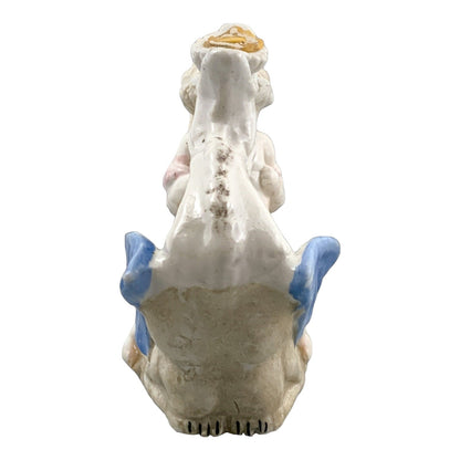 Georgian softpaste porcelain and creamware cherub candle chambersticks, putti on wyvern and leaf