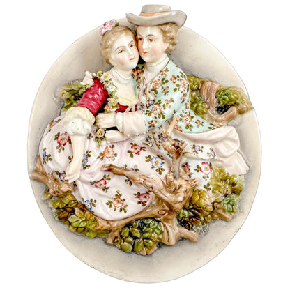 Pair early 19th Century porcelain Meissen style continental wall plaques, romantic scenes with lovers