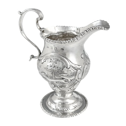 George III sterling milk jug on pedestal foot with hunting scenes, Walter Brind, 1770