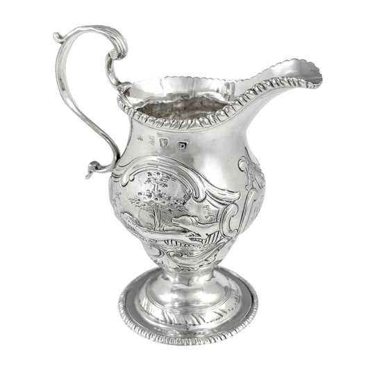 George III sterling milk jug on pedestal foot with hunting scenes, Walter Brind, 1770