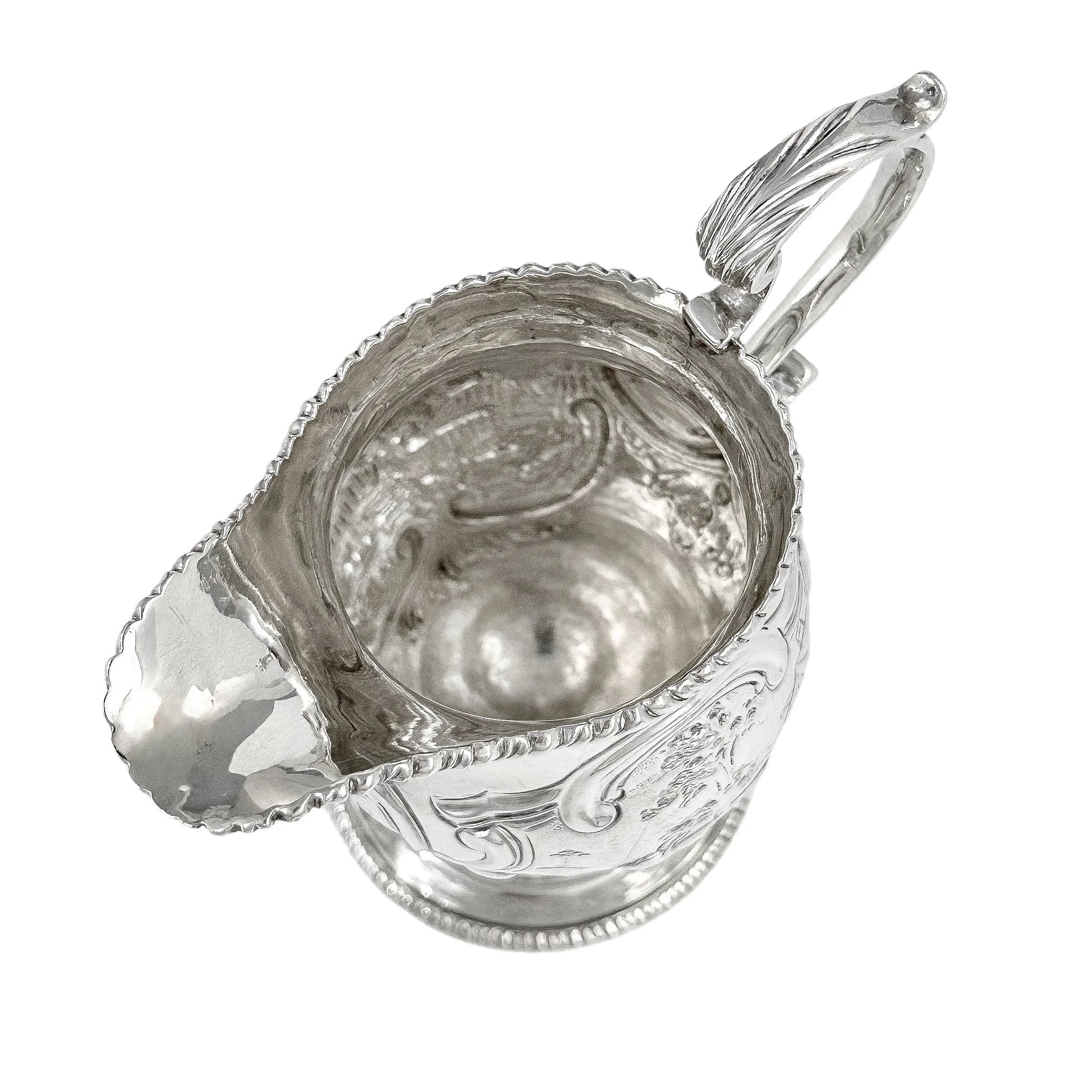 George III sterling milk jug on pedestal foot with hunting scenes, Walter Brind, 1770