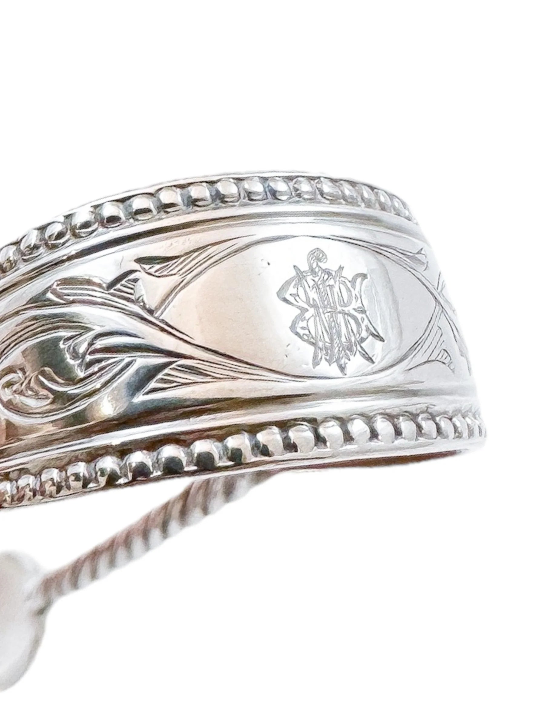 Early Victorian sterling silver sugar tongs with twisted arms and foliate engraving