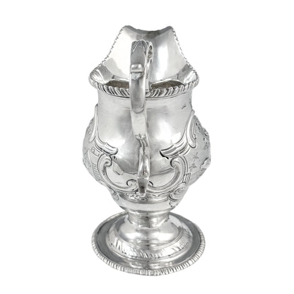 George III sterling milk jug on pedestal foot with hunting scenes, Walter Brind, 1770