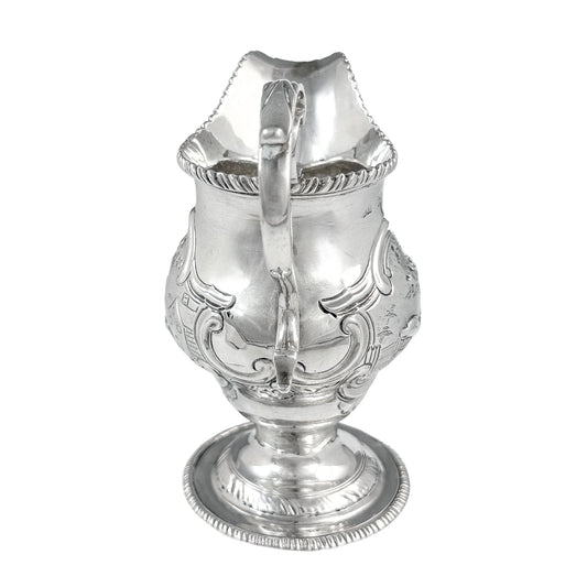 George III sterling milk jug on pedestal foot with hunting scenes, Walter Brind, 1770