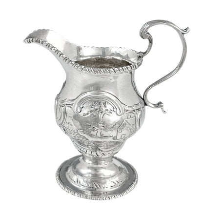 George III sterling milk jug on pedestal foot with hunting scenes, Walter Brind, 1770