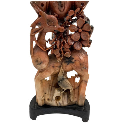 Qing dynasty red soapstone figural candlestick with deer, bird and prunus tree