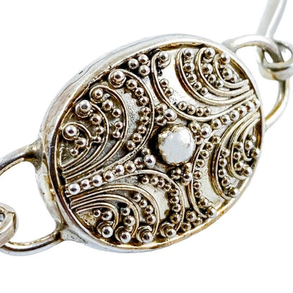 Suarti Bali sterling silver bangle bracelet with an oval medallion decorated with beaded scrolls