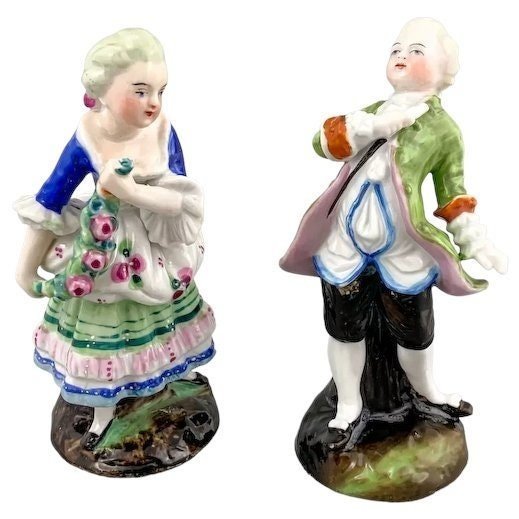 19th century German porcelain matching figurines – Regency gentleman and lady with flower garland