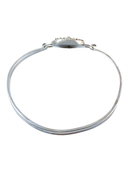 Suarti Bali sterling silver bangle bracelet with an oval medallion decorated with beaded scrolls