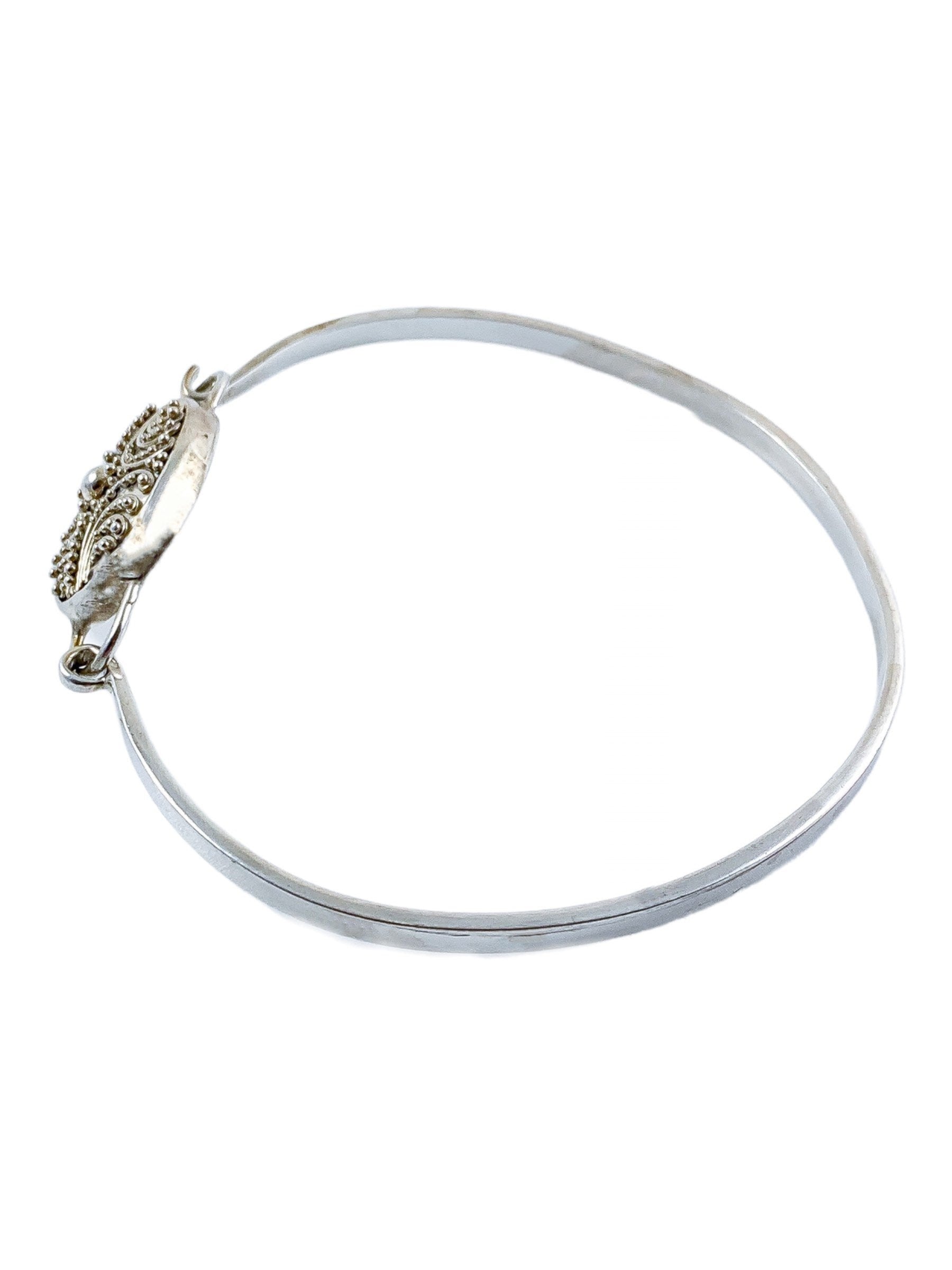 Suarti Bali sterling silver bangle bracelet with an oval medallion decorated with beaded scrolls