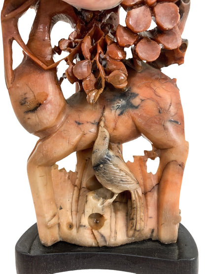 Qing dynasty red soapstone figural candlestick with deer, bird and prunus tree
