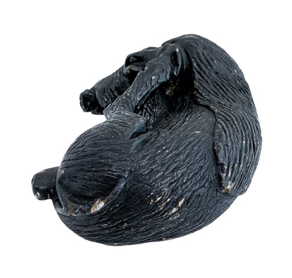 Folk art tribal African soapstone statue of a reclining warthog scratching its ear