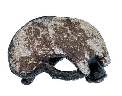 Folk art tribal African soapstone statue of a reclining warthog scratching its ear