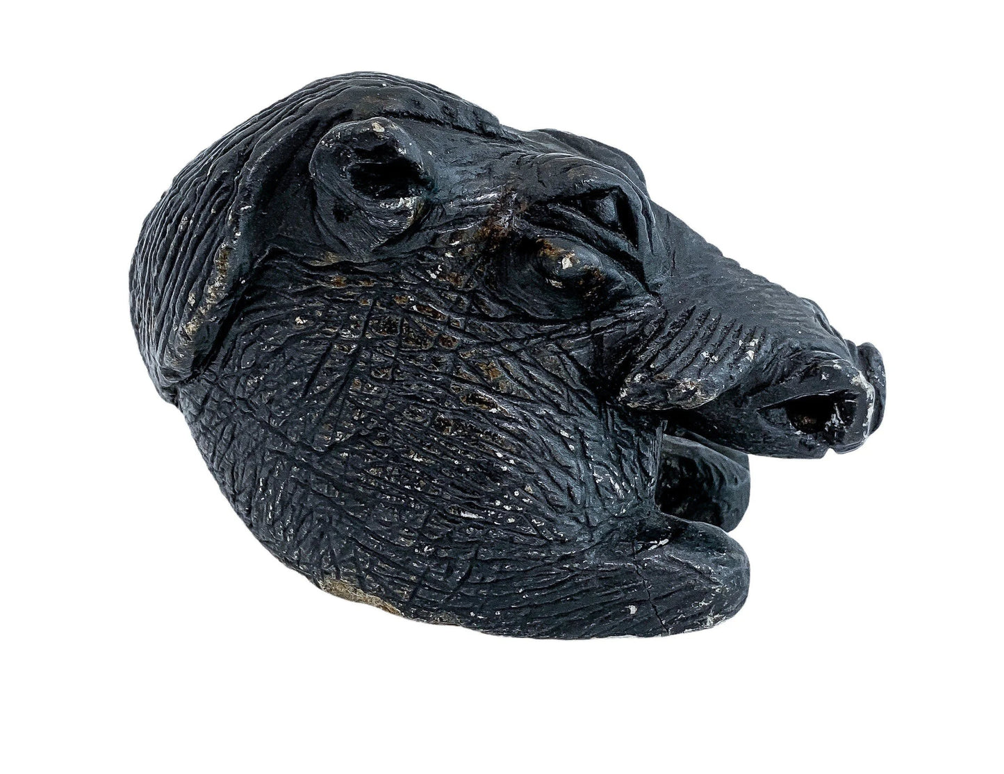 Folk art tribal African soapstone statue of a reclining warthog scratching its ear