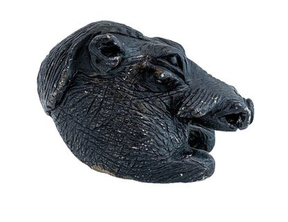Folk art tribal African soapstone statue of a reclining warthog scratching its ear