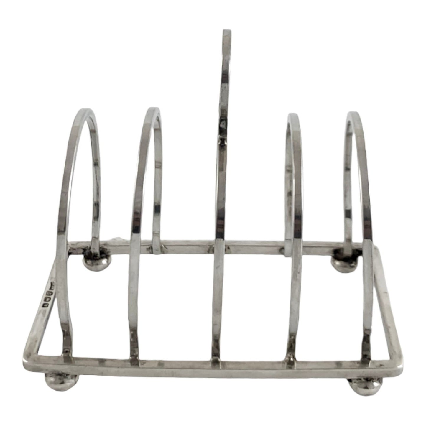 George V round sterling silver 4 slot 5 bar toast rack raised on bun feet, Walker & Hall