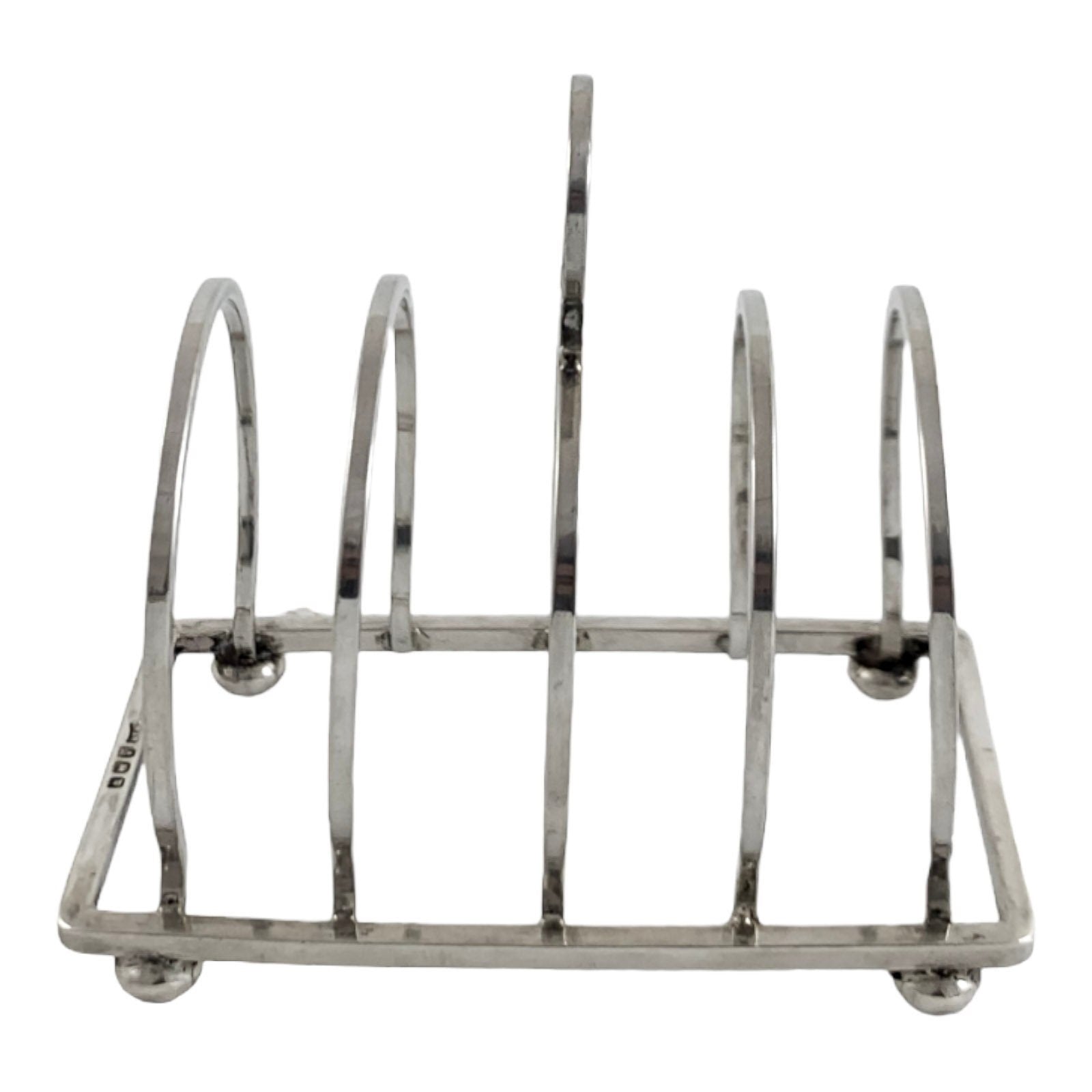George V round sterling silver 4 slot 5 bar toast rack raised on bun feet, Walker & Hall