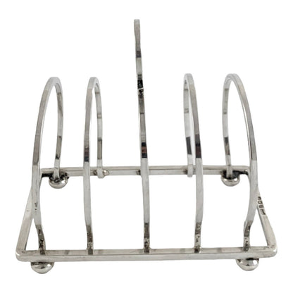 George V round sterling silver 4 slot 5 bar toast rack raised on bun feet, Walker & Hall