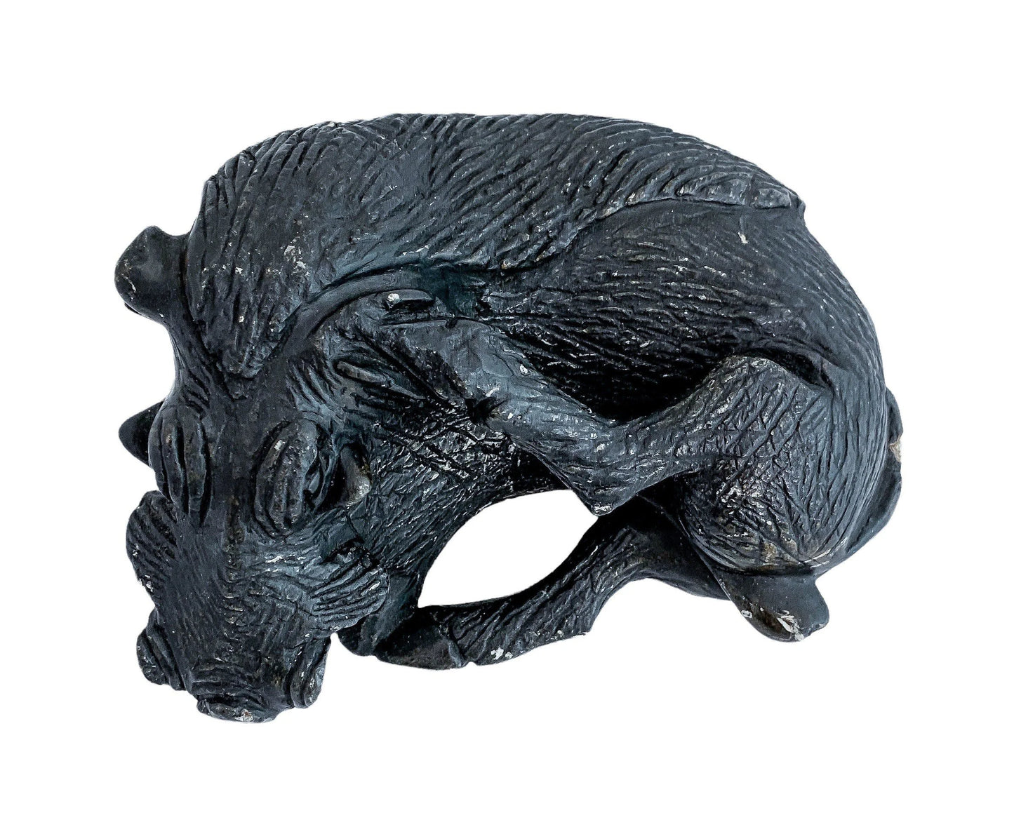 Folk art tribal African soapstone statue of a reclining warthog scratching its ear
