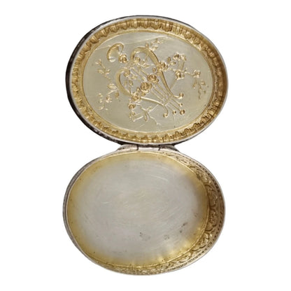 Antique Continental gilt solid silver oval snuff / pill box embossed with lyre and flower garlands