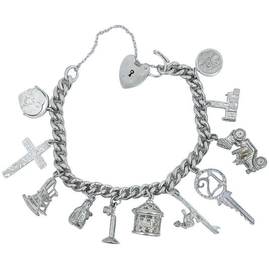 Vintage 1973 sterling silver charm bracelet with 11 charms and heart padlock, bear, car, rocking chair, surfer