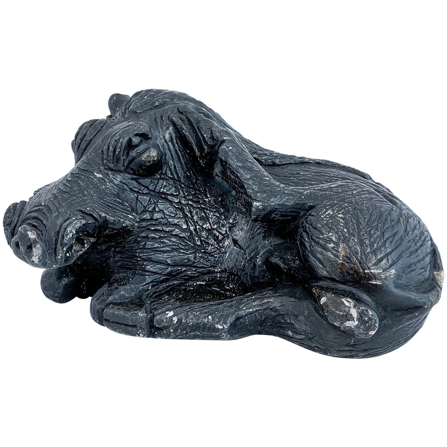 Folk art tribal African soapstone statue of a reclining warthog scratching its ear