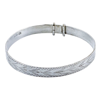 1970’s sterling silver child's adjustable "belt" bracelet with buckle detail and bright-cut leaf design