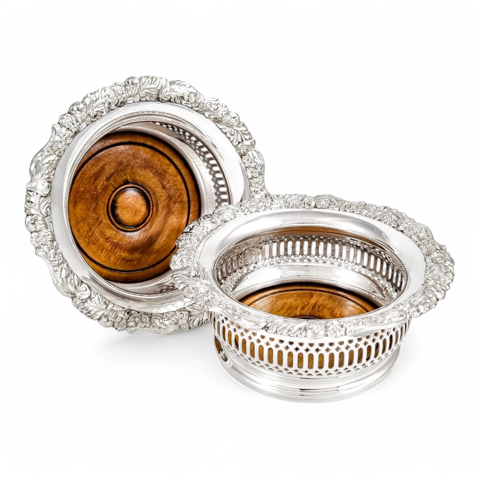 Antique silver plated magnum bottle coasters with Rococo foliate borders and mahogany bases, c. 1880s